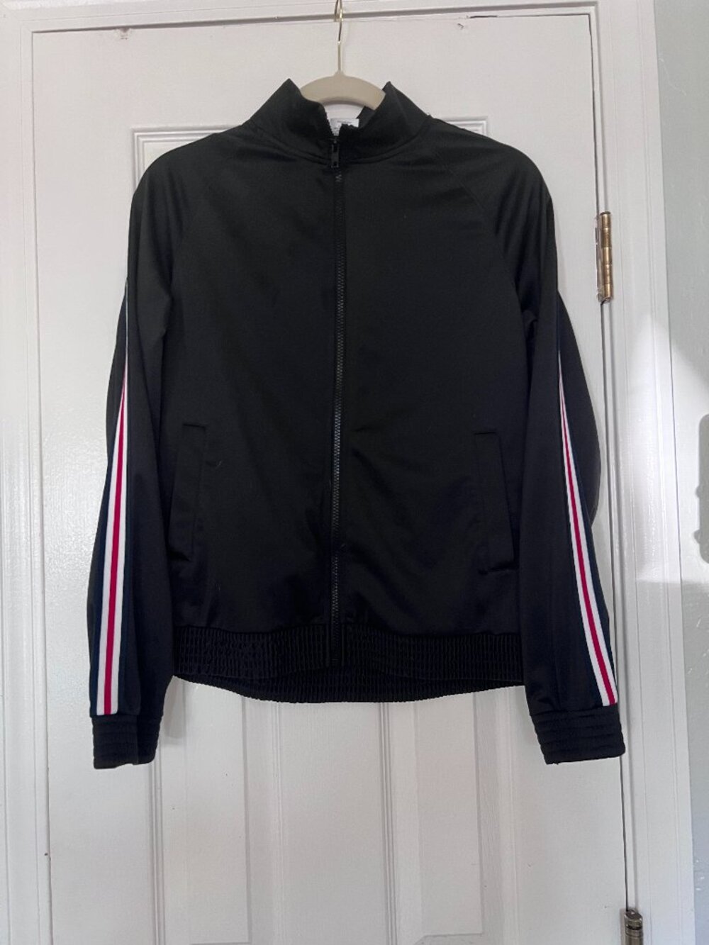 Kids black full zip jacket with white and red striping